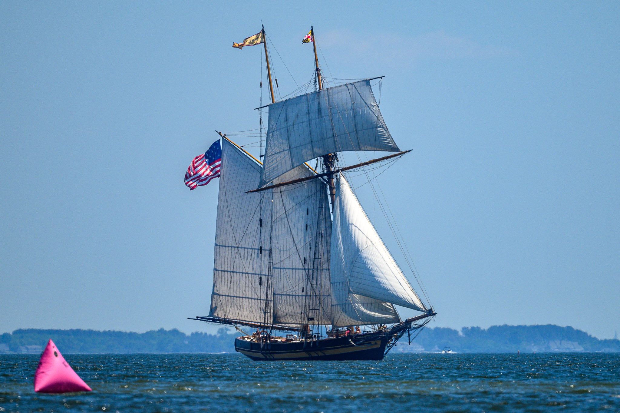 A tall ship sailing on the bay near the race course